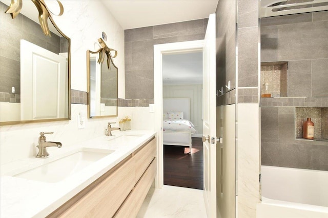 bathroom featuring shower / bath combination, vanity, and tile walls