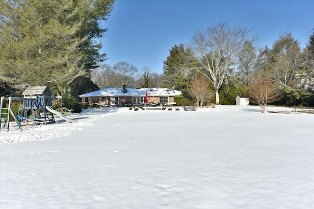 snowy yard with a playground