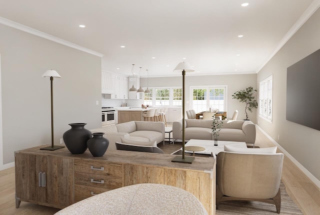 living room with ornamental molding and light hardwood / wood-style floors