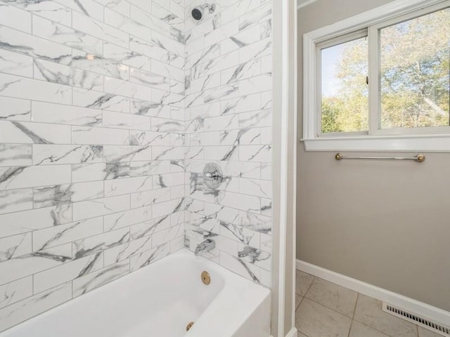 bathroom with tiled shower / bath and tile patterned flooring