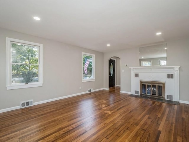 unfurnished living room with dark hardwood / wood-style floors