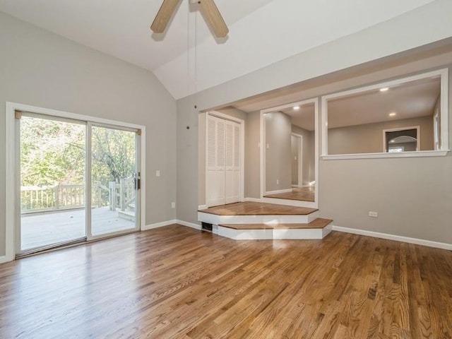 empty room featuring ceiling fan, vaulted ceiling, and hardwood / wood-style floors