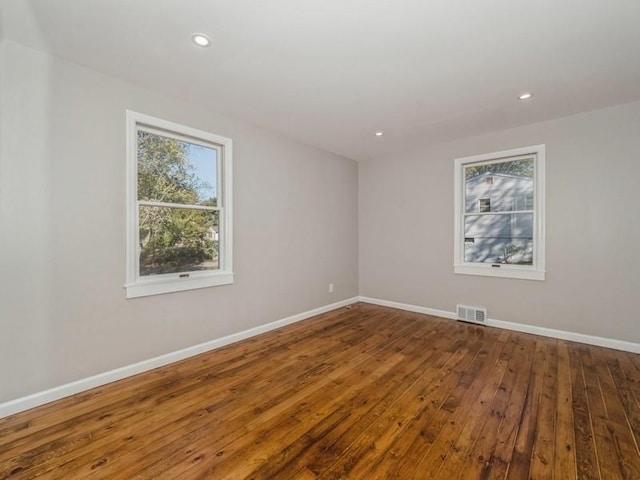 spare room with wood-type flooring