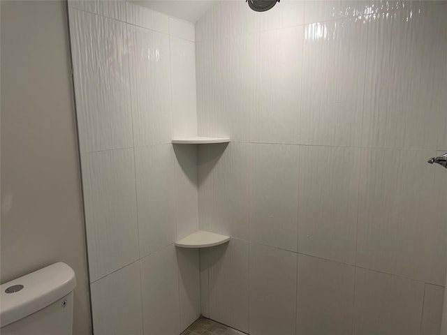 bathroom with a shower and toilet