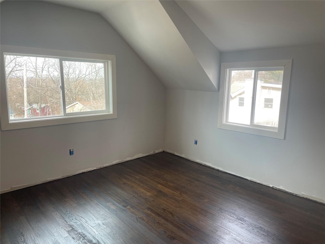 bonus room featuring lofted ceiling and dark hardwood / wood-style floors