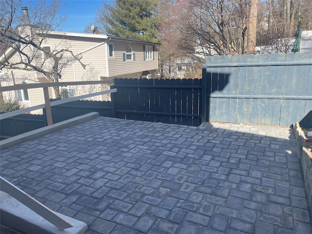 view of gate featuring a patio