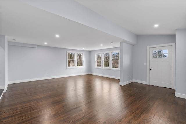 entryway with dark wood finished floors, recessed lighting, and baseboards