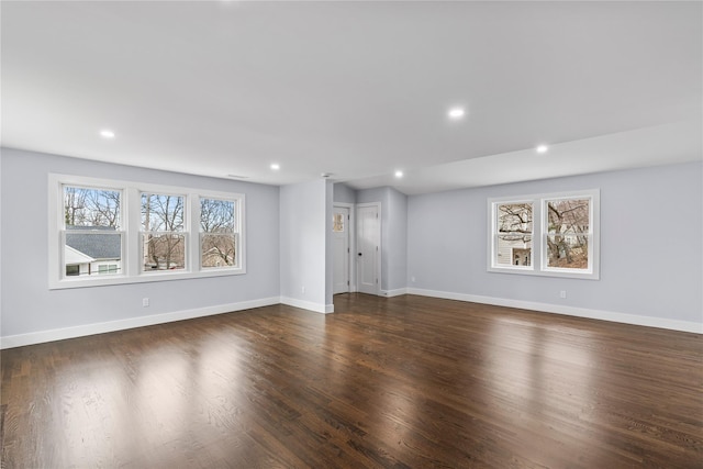 unfurnished living room featuring recessed lighting, dark wood-style flooring, and baseboards