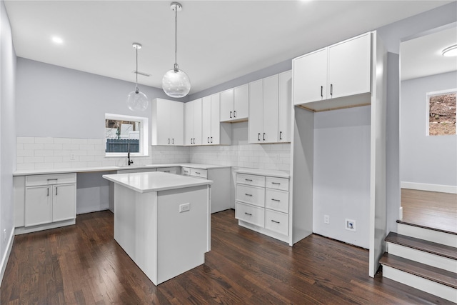 kitchen featuring backsplash, a kitchen island, and dark wood-type flooring