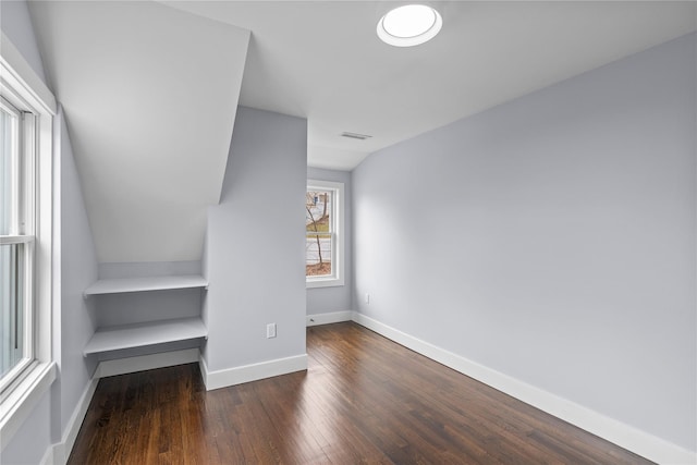 unfurnished bedroom featuring visible vents, wood finished floors, and baseboards