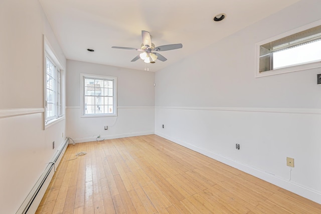 empty room with ceiling fan, a baseboard radiator, and light hardwood / wood-style flooring