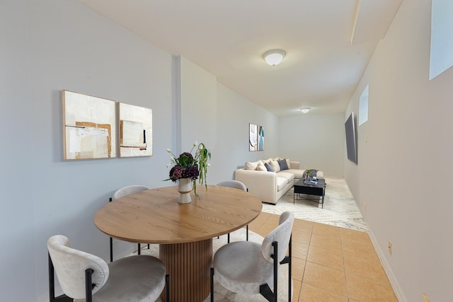 dining space featuring light tile patterned floors