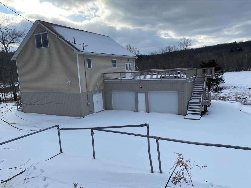 exterior space featuring a garage and a deck