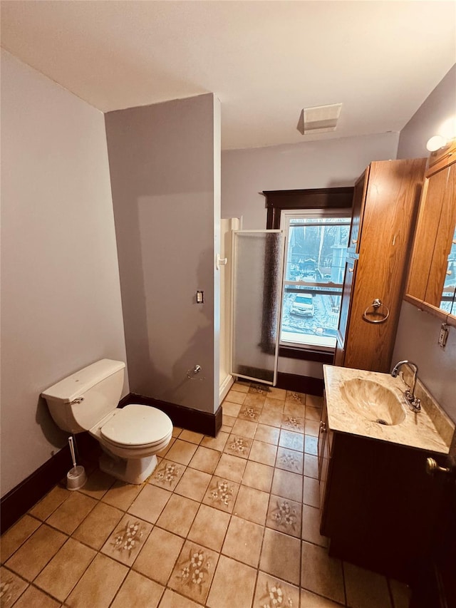 bathroom with vanity, an enclosed shower, tile patterned flooring, and toilet