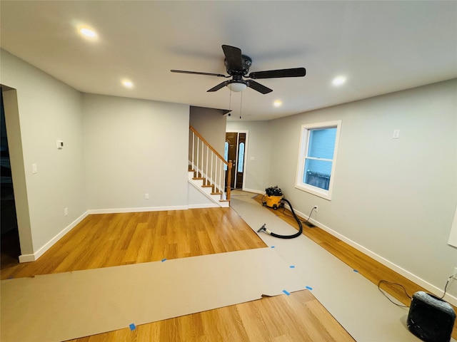 exercise area with ceiling fan and wood-type flooring