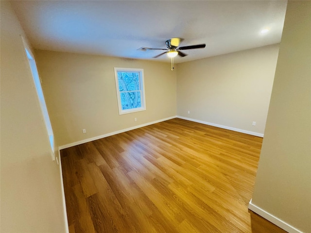 empty room with wood-type flooring and ceiling fan