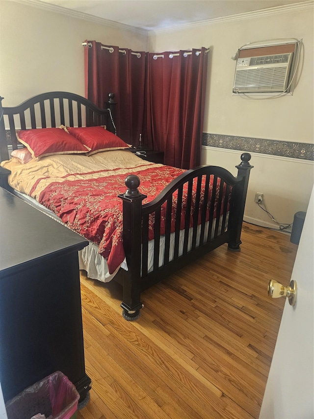 bedroom with a wall unit AC and light hardwood / wood-style flooring