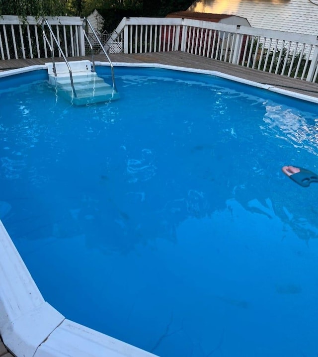 view of swimming pool featuring a wooden deck