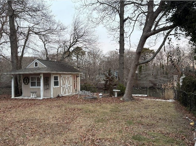 view of outdoor structure with a water view and a yard