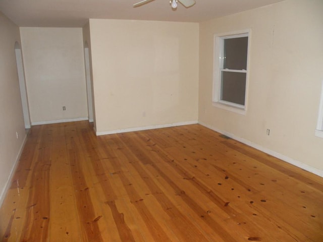 empty room with ceiling fan and light hardwood / wood-style floors