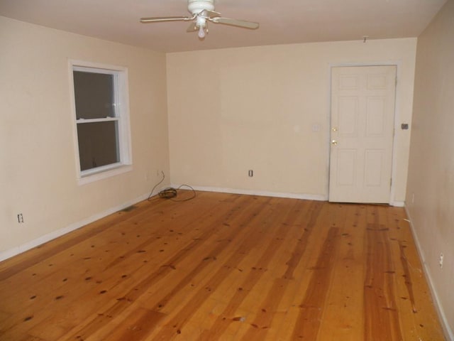 spare room with hardwood / wood-style flooring and ceiling fan