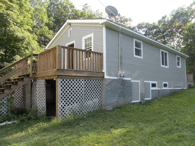 rear view of property with a yard and a deck