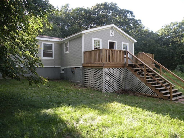 back of property with a lawn and a deck