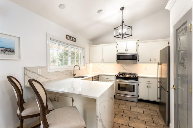 kitchen featuring sink, white cabinetry, kitchen peninsula, pendant lighting, and stainless steel appliances