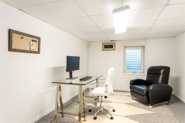 office area with a paneled ceiling