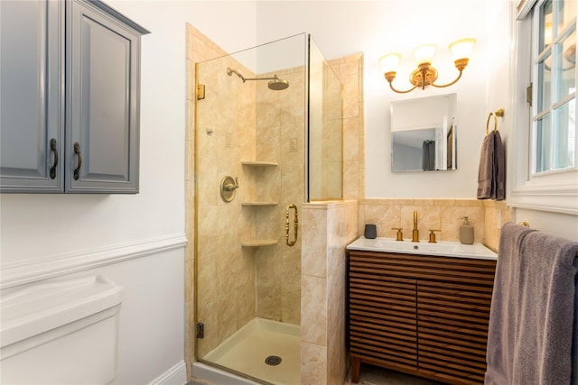 bathroom featuring vanity, toilet, and a shower with shower door