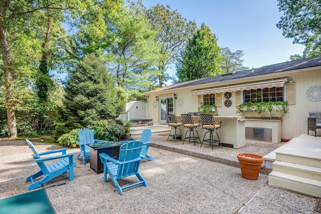 view of patio featuring an outdoor bar and a fire pit