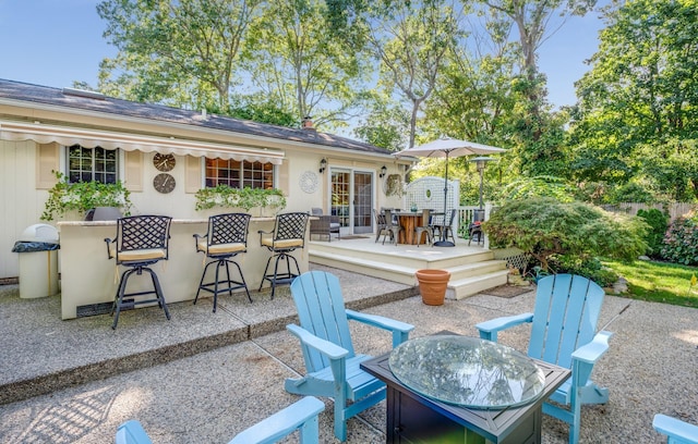 view of patio / terrace featuring an outdoor fire pit and a bar