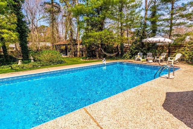 view of swimming pool with a gazebo and a patio