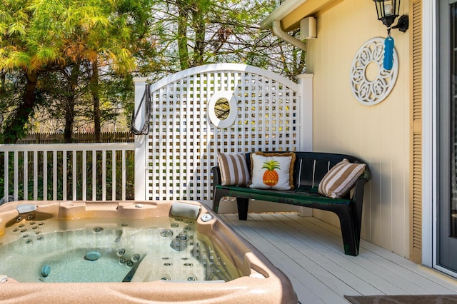 wooden terrace with an outdoor hot tub