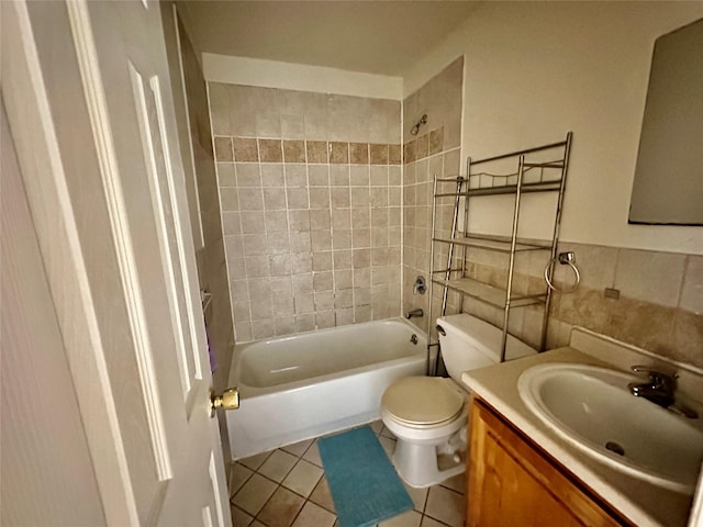 full bath featuring tile patterned flooring, toilet, shower / tub combination, vanity, and tile walls