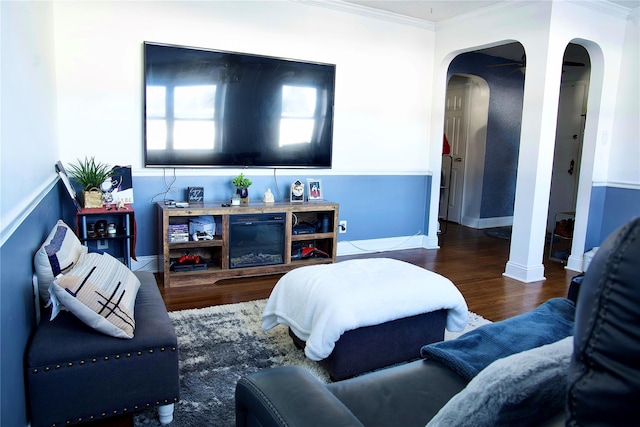 living room with wood-type flooring and ornamental molding