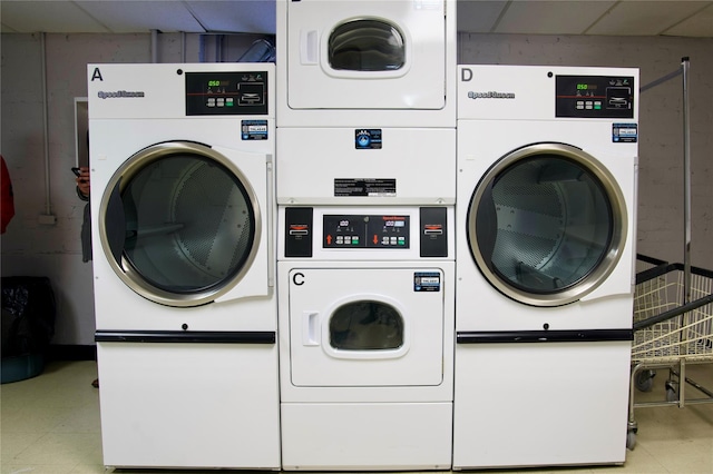 clothes washing area with stacked washer and dryer and washer and clothes dryer