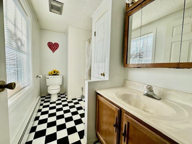 bathroom featuring vanity, a baseboard radiator, and toilet