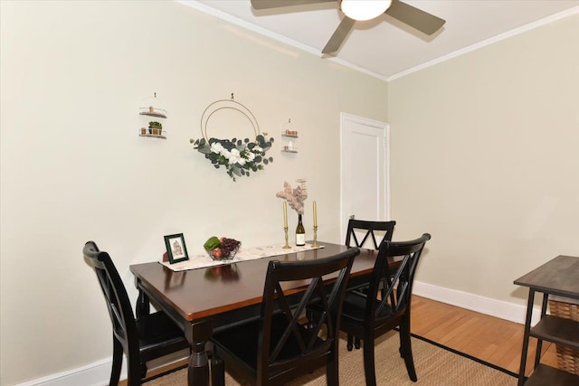 dining space with crown molding, wood-type flooring, and ceiling fan