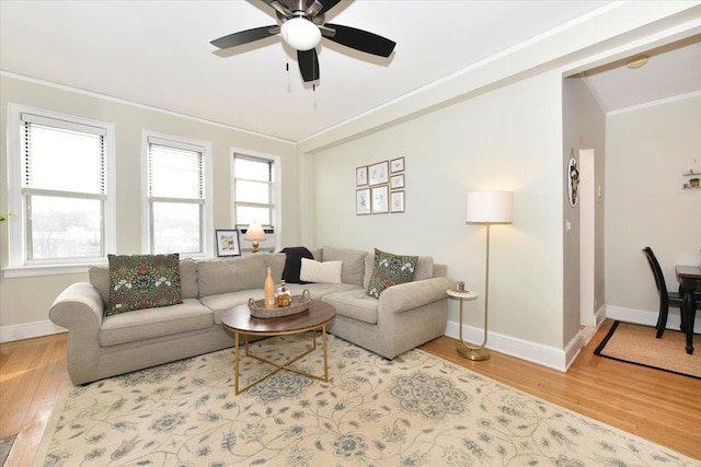 living room with crown molding, ceiling fan, and hardwood / wood-style flooring