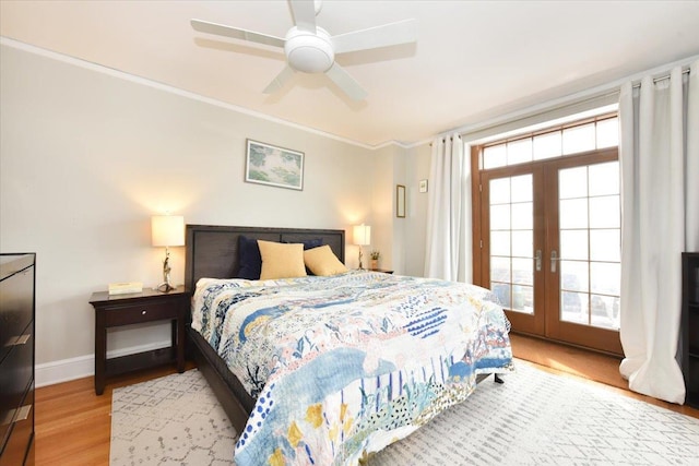 bedroom with ornamental molding, ceiling fan, light hardwood / wood-style floors, and french doors