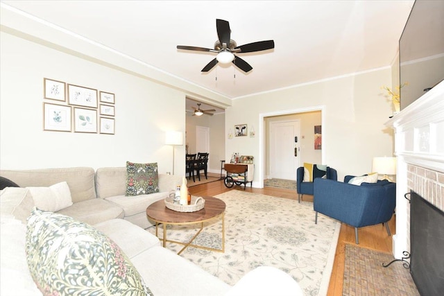 8 Barstow Rd Unit 7-E, Great Neck, NY 11021 - living room featuring a ceiling fan, wood finished floors, ornamental molding, and a brick fireplace