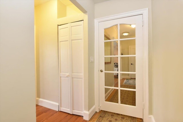 8 Barstow Rd Unit 7-E, Great Neck, NY 11021 - doorway to outside featuring wood finished floors and baseboards