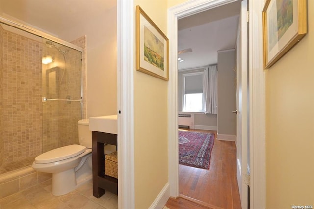 8 Barstow Rd Unit 7-E, Great Neck, NY 11021 - bathroom featuring radiator, toilet, a stall shower, and vanity