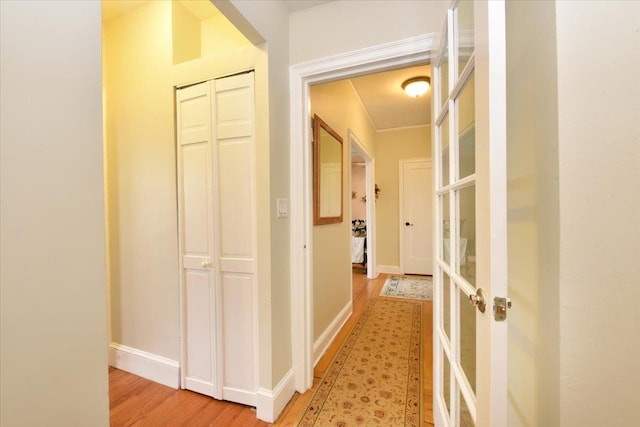 8 Barstow Rd Unit 7-E, Great Neck, NY 11021 - hallway with light wood-style flooring, french doors, and baseboards