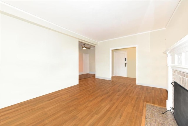 8 Barstow Rd Unit 7-E, Great Neck, NY 11021 - unfurnished living room with a fireplace with flush hearth, light wood-style flooring, and ornamental molding