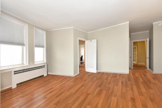 8 Barstow Rd Unit 7-E, Great Neck, NY 11021 - unfurnished room with radiator, ornamental molding, and light wood-style floors