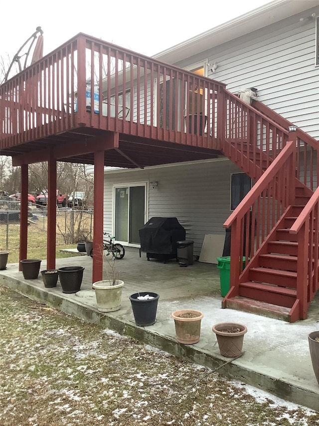 exterior space featuring a wooden deck and a grill