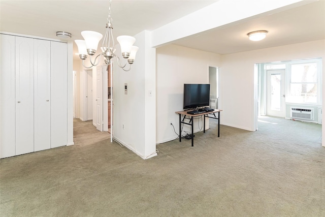 living area with carpet, a wall unit AC, and a notable chandelier