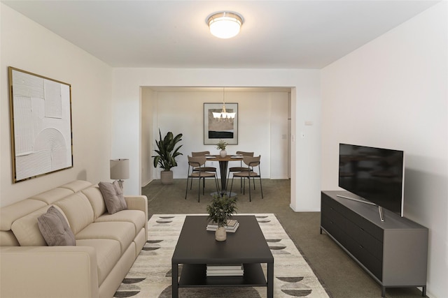 carpeted living area featuring a chandelier